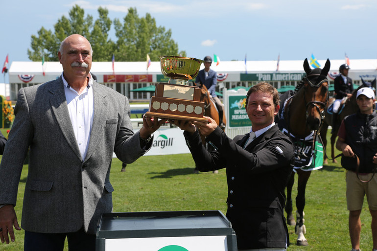 Alberto Michan (MEX) hoist the champions trophy with Mike Bud, Sales Manager, Cargill. Photo (c) Spruce Meadows Media Services. 