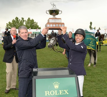 Kent Farrington (USA) Hoists the Rolex Champions Trophy with Tom Heathcott. Photo (c) Spruce Meadows Media Services. 