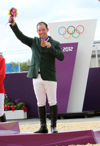 Cian O'Connor with his bronze medal. Photo by © 2012 Ken Braddick/dressage-news.com.