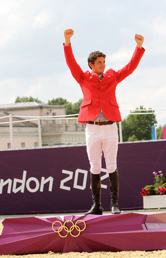 Steve steps to the podium to receive his gold medal. Photo by © 2012 Ken Braddick/dressage-news.com.