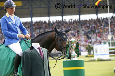 Codex One takes a close look at his trophy after winning the Rolex Grand Prix in Aachen, also securing Christian Ahlmann the blazer that all the winners of the famous Grand Prix get the honor of wearing.