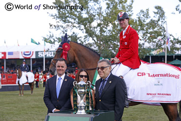 Ian Millar and Dixson in the winner's circle after winning the Grand Prix at Spruce Meadows