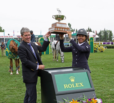 Tom Heathcott presents the Pan American Cup to grand prix winner Kent Farrington. Photos (c) Spruce Meadows Media Services.