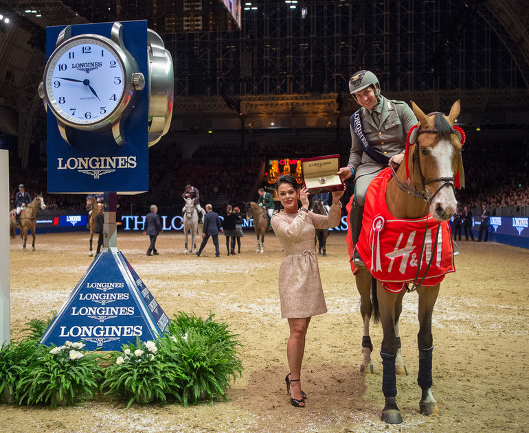 Emanuele Gaudiano is presented with a Longines watch by Katrina Jones, Branding Director, Longines UK and Ireland. Photo (c) Jon Stroud/FEI. 