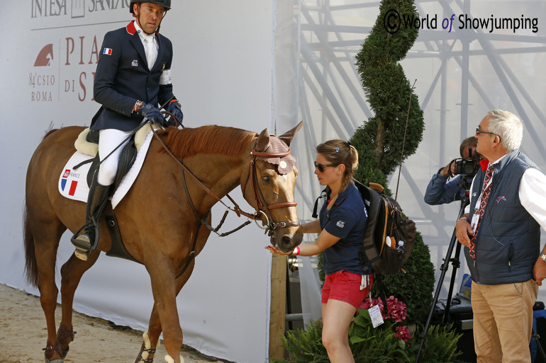 World no. one Simon Delestre leaving the ring to catch up with Chef d'Equipe Philippe Guerdat.