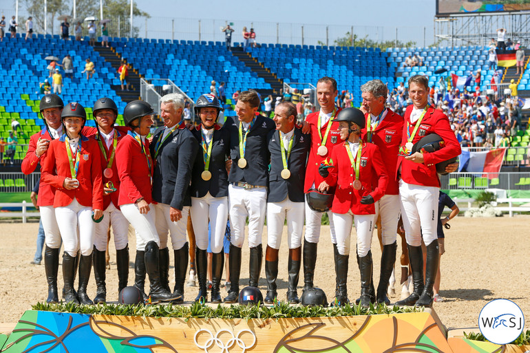 Beezie Madden trying to get a place on the podium for the group photo. 