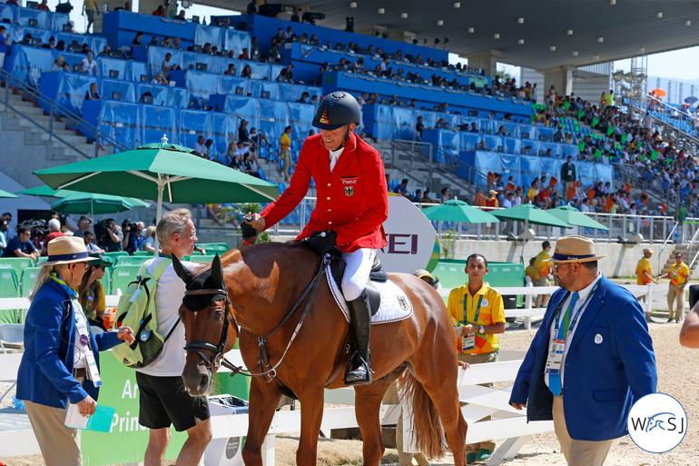 A high five after Ludger Beerbaum and Casello secure a jump-off against Canada with a clear round. Photo (c) Jenny Abrahamsson.