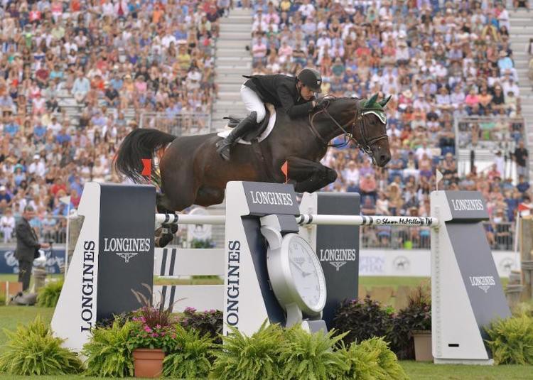 Ireland's Kevin Babington and Shorapur winning the $250,000 Hampton Classic Grand Prix in 2014. Photo (c) Classic Communications.com.