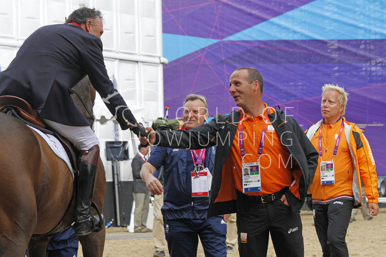 Dutch reserve rider Leon Thijssen shakes hands with Peter Charles.