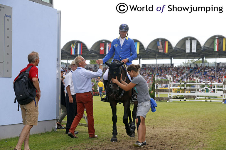 Heiner Engemann congratulates a happy Christian Ahlmann as he leaves the ring on Codex One after another clear round in the Rolex Grand Prix. The pair eventually went on to win this prestigious class. 