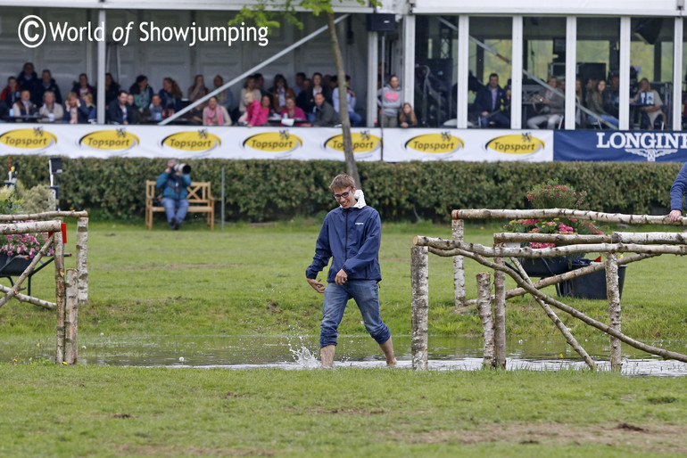 This guy had the coldest job - to lift the poles up in the water fence!