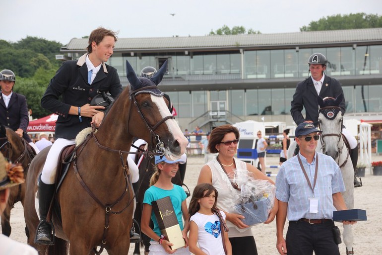 Martin Fuchs - here on a borrowed horse for the prize giving cermony - won the Grand Prix qualifier in Mons on Saturday. Photo (c) World of Showjumping.