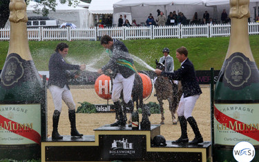 The riders on the podium soaked each other in champagne after the Grand Prix. 