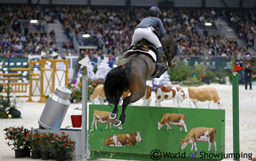 Voyeur tackles the cow wall with Kent Farrington in the saddle to go clear.