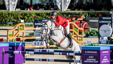 Defending champions from Belgium top first-round nail-biter