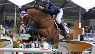 Joe Clee climbs to the top of the podium in Gent Grand Prix