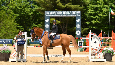 Margie Engle plays her Jackofhearts to kick off Traverse City Spring Horse Shows