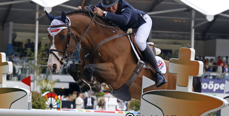 Joe Clee climbs to the top of the podium in Gent Grand Prix